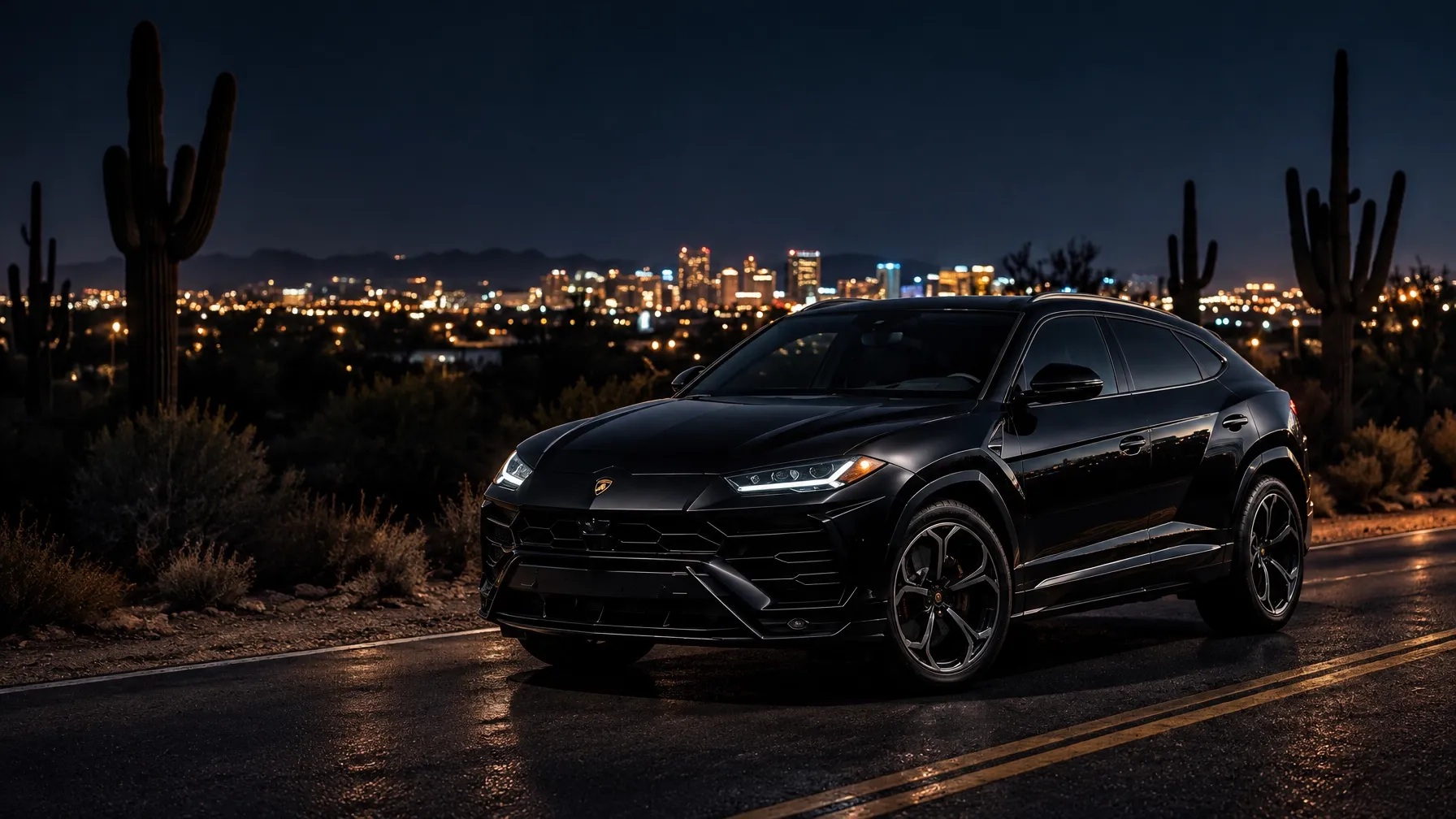 Black luxury SUV on a Scottsdale road at night beneath the desert skyline